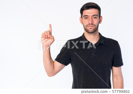 Portrait of young bearded Persian man pointing up 57799802