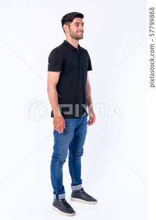 Full body shot of happy young bearded Persian man thinking Full body shot of happy young bearded Persian man thinking 57799868