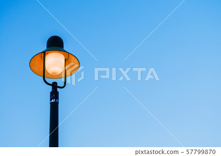 Vintage retro light pole with blue sky background Vintage retro light pole with blue sky background 57799870