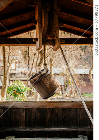 Old antique Water well wooden bucket with rope 57799873