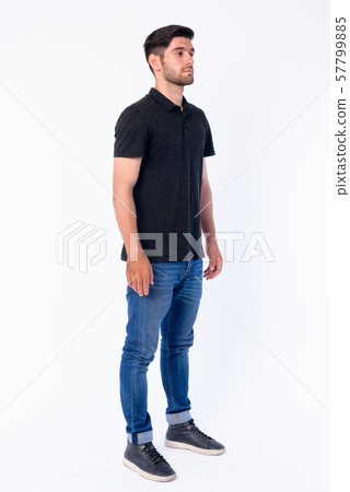 Full body shot of young bearded Persian man thinking Full body shot of young bearded Persian man thinking 57799885