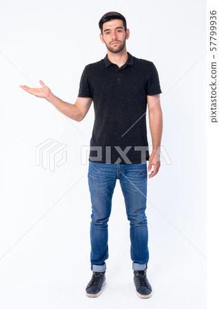 full body picture of a young casual man presenting Stock Photo