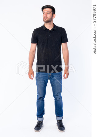 Full body shot of young bearded Persian man thinking and looking up 57799971