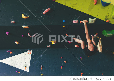 Woman in boulder gym. 57799993