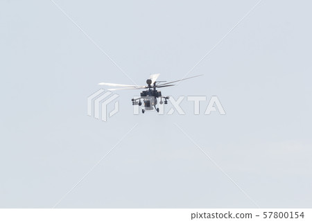 A military helicopter with huge blades flying in the white sky 57800154