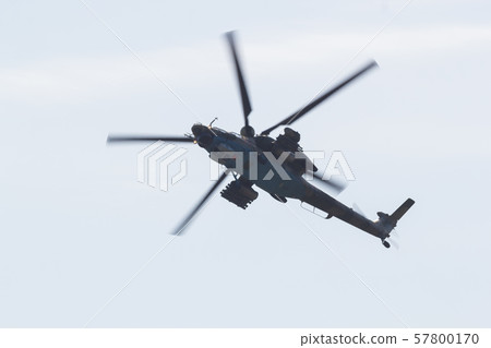 A military helicopter with red stars on the the bottom panel flying in the white sky A military helicopter with red stars on the the bottom panel flying in the white sky 57800170