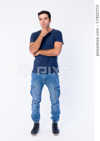 Full body shot of young handsome Persian man thinking and looking up 57800355