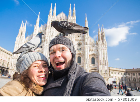 Winter travel and vacations concept - Happy tourists taking a self portrait with funny pigeons in Winter travel and vacations concept - Happy tourists taking a self portrait with funny pigeons in 57801309