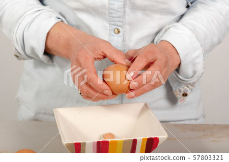 close up of hands of woman shells hard-boiled egg 57803321
