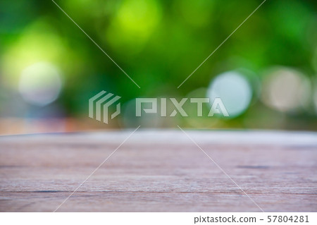Empty curved wooden table texture, Green garden blurred bokeh background, Selective focus Empty curved wooden table texture, Green garden blurred bokeh background, Selective focus 57804281