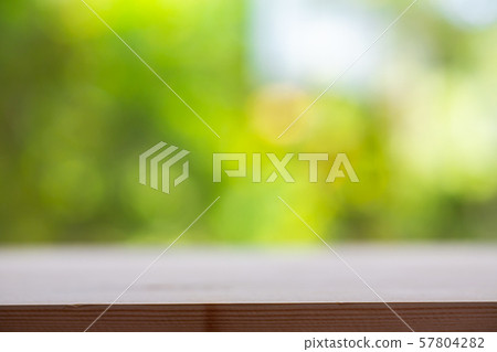 Empty wooden table texture, Green garden blurred bokeh background, Selective focus Empty wooden table texture, Green garden blurred bokeh background, Selective focus 57804282