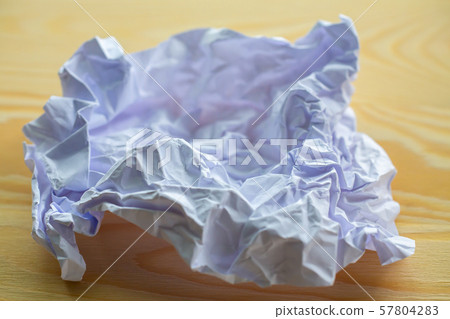 Crumpled white paper on wood table, Close up & Macro shot, Selective focus, Brainstorming, Creative idea, Business concept Crumpled white paper on wood table, Close up & Macro shot, Selective focus, Brainstorming, Creative idea, Business concept 57804283