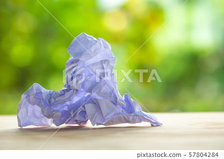 Crumpled white paper on wood table, Bokeh green garden background, Close up & Macro shot, Selective focus, Brainstorming, Creative idea, Business concept Crumpled white paper on wood table, Bokeh green garden background, Close up & Macro shot, Selective focus, Brainstorming, Creative idea, Business concept 57804284