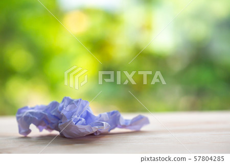 Crumpled white paper on wood table, Bokeh green garden background, Close up & Macro shot, Selective focus, Brainstorming, Creative idea, Business concept Crumpled white paper on wood table, Bokeh green garden background, Close up & Macro shot, Selective focus, Brainstorming, Creative idea, Business concept 57804285
