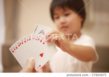 Boys playing on playing cards Boys playing on playing cards 57804875