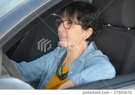 brunette mature woman driving car brunette mature woman driving car 57805670