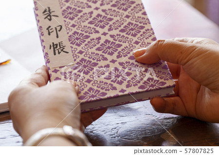 Woman hand holding a red stamp book 57807825