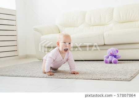 beautiful smiling baby crawling for the first time. beautiful smiling baby crawling for the first time. 57807864