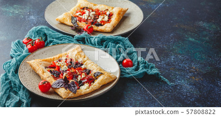 Tomato tarts with addition of aromatic herbs Tomato tarts with addition of aromatic herbs 57808822