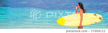 Beautiful fitness surfer woman surfing during summer vacation Beautiful fitness surfer woman surfing during summer vacation 57809112
