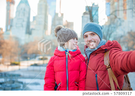 Adorable little girl and dad have fun in Central Park at New York City 57809317