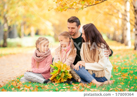 Portrait of happy family of four in autumn day Portrait of happy family of four in autumn day 57809364