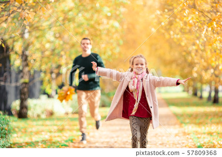 Family of dad and kid on beautiful autumn day in the park Family of dad and kid on beautiful autumn day in the park 57809368