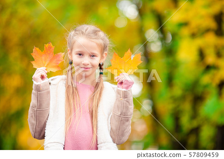 Adorable little girl at beautiful autumn day outdoors 57809459