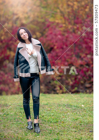 Beautiful girl in autumn park outdoors on sunny day Beautiful girl in autumn park outdoors on sunny day 57809473