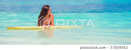 Beautiful fitness surfer woman surfing during summer vacation Beautiful fitness surfer woman surfing during summer vacation 57809562