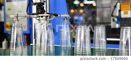 Plastic cup on conveyor belt in distribution warehouse.parcels transportation system concept. Plastic cup on conveyor belt in distribution warehouse.parcels transportation system concept. 57809666