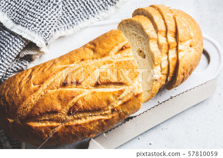 Sliced wheat bread on the white board. 57810059