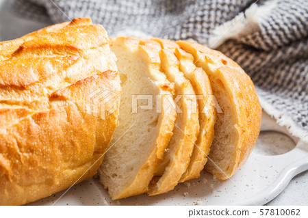 Sliced wheat bread on the white board. 57810062