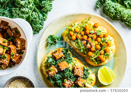Vegan open sandwiches with guacamole, tofu 57810203