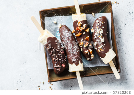 Vegan dessert for kids. Banana in dark chocolate 57810268