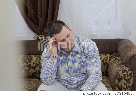 Young man sits on a sofa in a wedding salon. 57810493