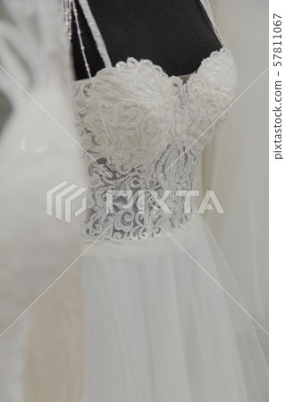 Beautiful wedding dresses in a bridal salon. Beautiful wedding dresses in a bridal salon. 57811067