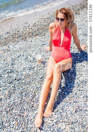 Outdoor portrait of woman on the beach. Outdoor portrait of woman on the beach. 57811186