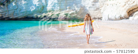 Cute little girl at beach during summer vacation Cute little girl at beach during summer vacation 57812590