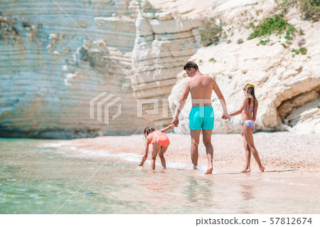 Father and two daughters on Caribbean beach Father and two daughters on Caribbean beach 57812674