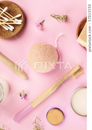 Plastic-free, zero waste cosmetics, flat lay pattern on a pink background. Bamboo toothbrushes and 57813550
