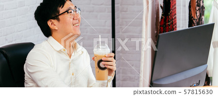 Happy clothing Asian entrepreneur enjoying and drinking coffee at office Happy clothing Asian entrepreneur enjoying and drinking coffee at office 57815630