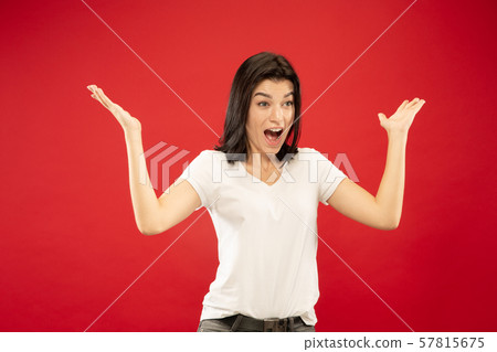 Caucasian young woman's half-length portrait on red background Caucasian young woman's half-length portrait on red background 57815675