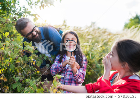 School children with teacher on field trip in nature, learning science. 57816153