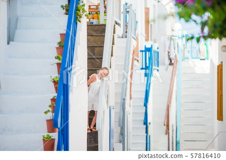 Beautiful girl at street of greek traditional village on Mykonos 57816410