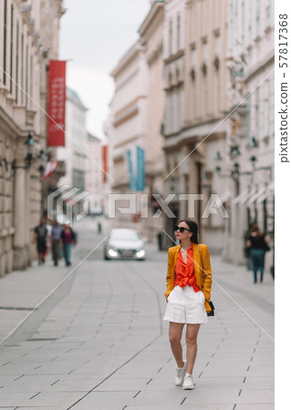 Woman walking in city. Young attractive tourist outdoors in italian city 57817368