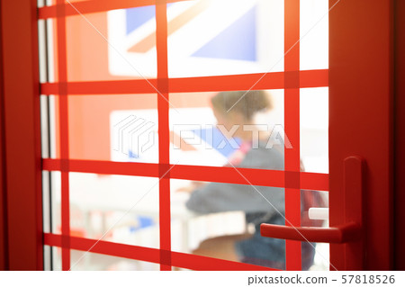 Young woman passes a test behind a closed door in a room. Selective focus. Young woman passes a test behind a closed door in a room. Selective focus. 57818526