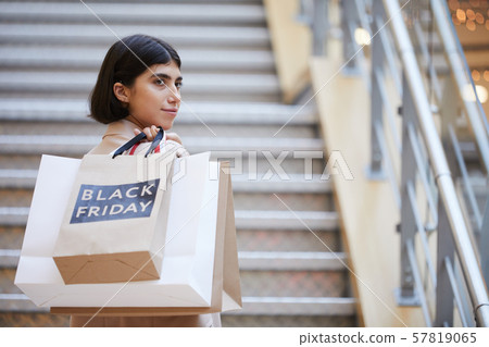 Young Woman Holding Shopping Bags on Black Friday 57819065