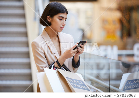 Elegant Woman Leaving Boutique 57819068