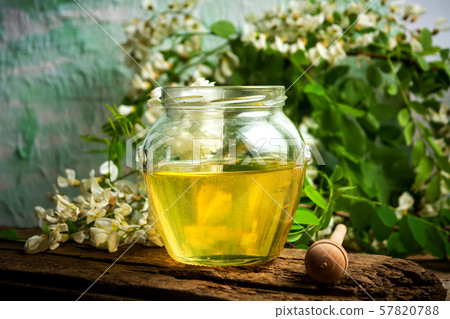 Honey in a jar with acacia flowers 57820788